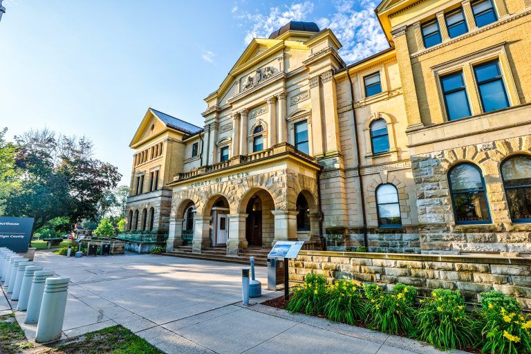 The Elgin County Courthouse in St. Thomas, a yellow-brick heritage building with arched stone entrances.